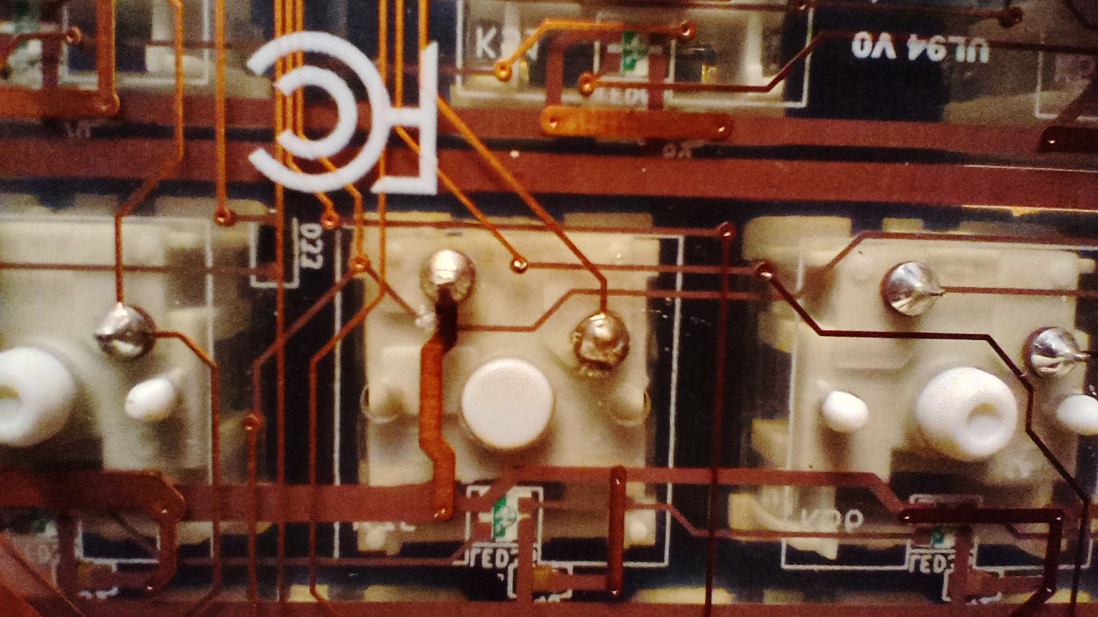 Underside view through a transparent PCB of 3 keyboard switches in a C64U Starlight Edition.